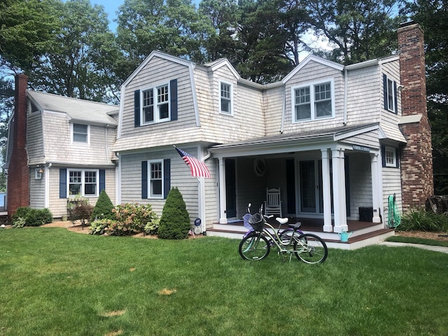 122 Point Of Pines Ave, Centerville, MA 02632 - view of front of home featuring a gambrel roof, a chimney, and a front lawn