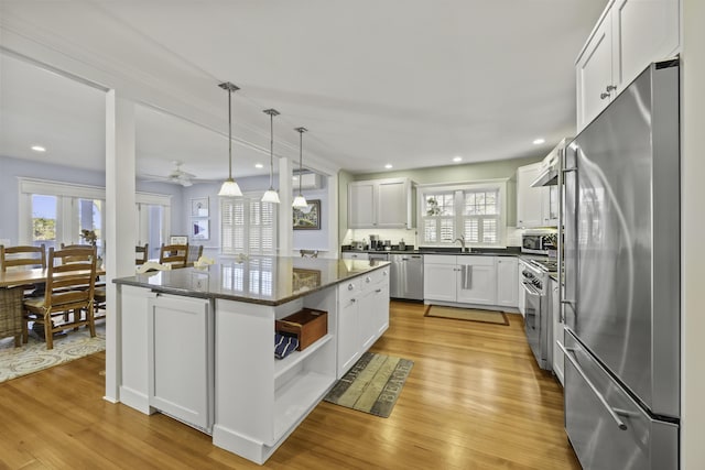 122 Point Of Pines Ave, Centerville, MA 02632 - kitchen featuring appliances with stainless steel finishes, open shelves, plenty of natural light, a sink, and recessed lighting