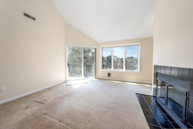 unfurnished living room with baseboards, plenty of natural light, high vaulted ceiling, and visible vents
