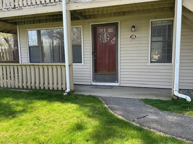 property entrance with a yard