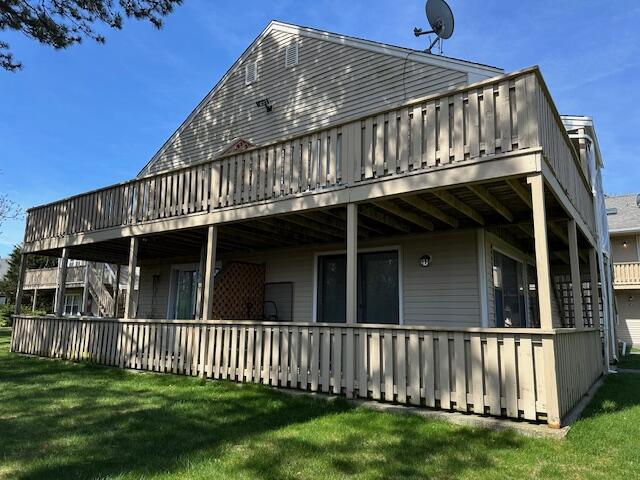 back of house with a yard and a deck