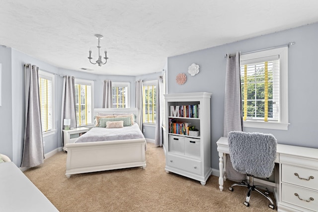 5 Bosuns Ln, Bourne, MA 02532 - bedroom featuring light colored carpet, multiple windows, a chandelier, an office area, and a textured ceiling