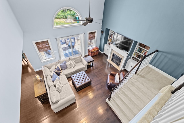 5 Bosuns Ln, Bourne, MA 02532 - living room featuring a ceiling fan, a fireplace with flush hearth, wood finished floors, and a towering ceiling