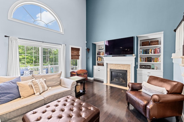 5 Bosuns Ln, Bourne, MA 02532 - living area with a fireplace with flush hearth, a high ceiling, and dark wood-style floors