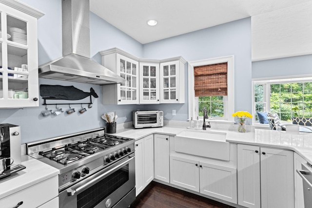 5 Bosuns Ln, Bourne, MA 02532 - kitchen featuring high end stainless steel range oven, wall chimney range hood, white cabinets, dark wood-style floors, and light countertops