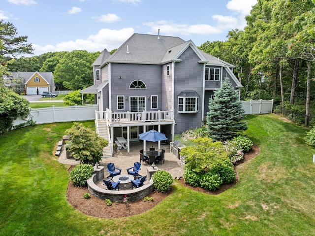 5 Bosuns Ln, Bourne, MA 02532 - rear view of house with an outdoor fire pit, a patio area, a wooden deck, stairs, and a fenced backyard