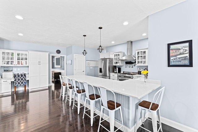 5 Bosuns Ln, Bourne, MA 02532 - kitchen with wall chimney range hood, stainless steel appliances, white cabinetry, and recessed lighting