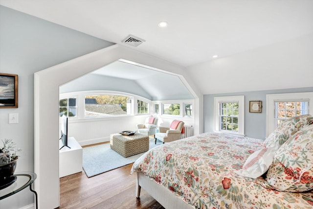 bedroom with hardwood / wood-style floors and lofted ceiling