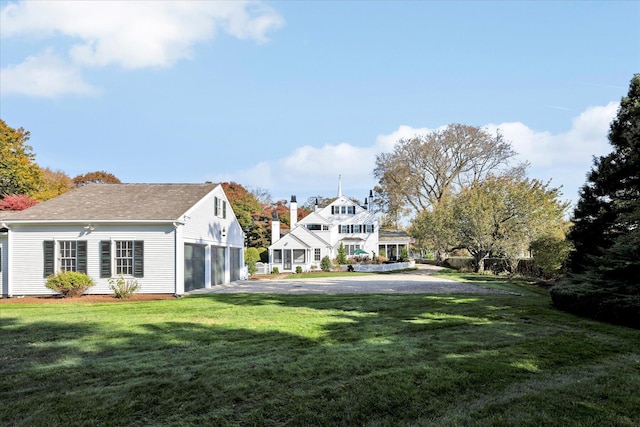 exterior space with a yard and a garage