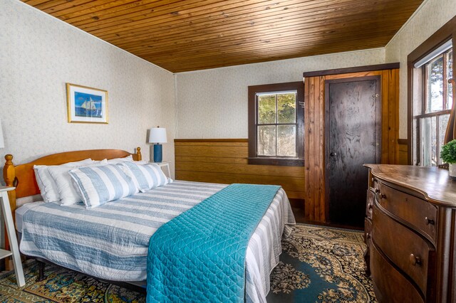 150 Old State Hwy Unit 4, Eastham, MA 02642 - bedroom with wood ceiling, wainscoting, and wallpapered walls