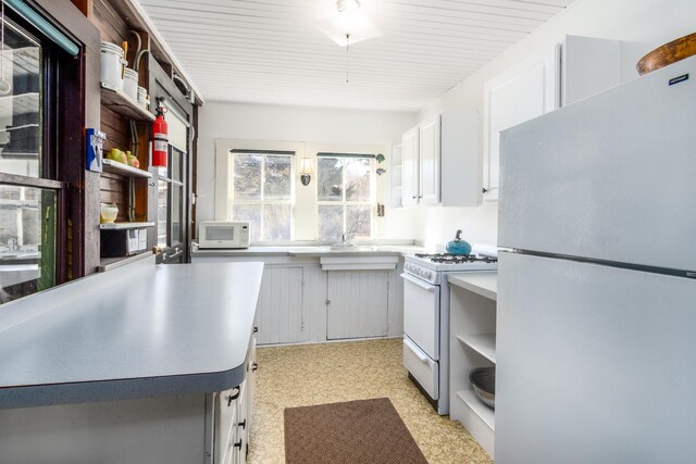 150 Old State Hwy Unit 4, Eastham, MA 02642 - kitchen featuring a ceiling fan, open shelves, white appliances, white cabinets, and light countertops