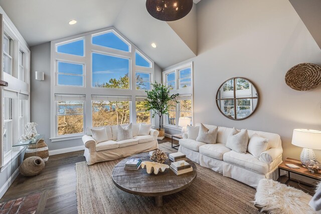 living area featuring recessed lighting, high vaulted ceiling, baseboards, and wood finished floors