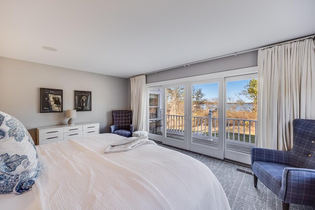 carpeted bedroom featuring visible vents and access to outside