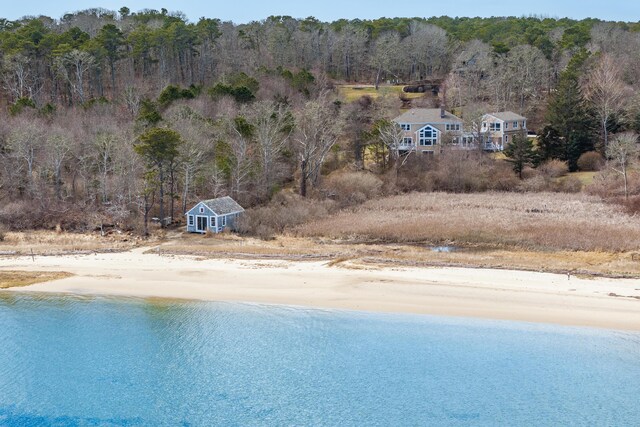 birds eye view of property featuring a water view and a forest view