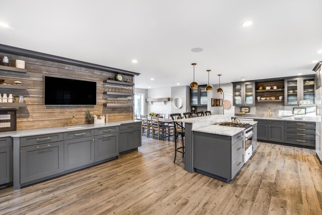 kitchen featuring gray cabinets, tasteful backsplash, and open shelves