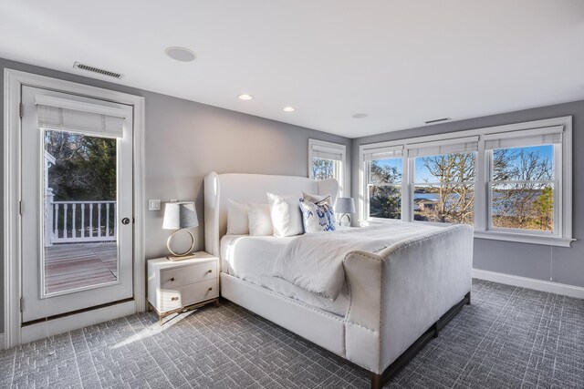 bedroom with dark colored carpet, recessed lighting, baseboards, access to outside, and visible vents