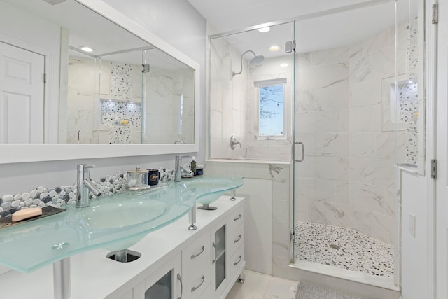 bathroom featuring a shower with shower door, vanity, and tile patterned flooring