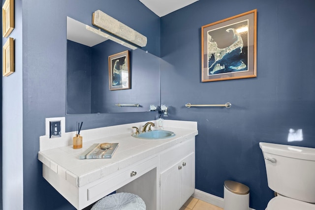 bathroom with toilet, tile patterned flooring, and vanity