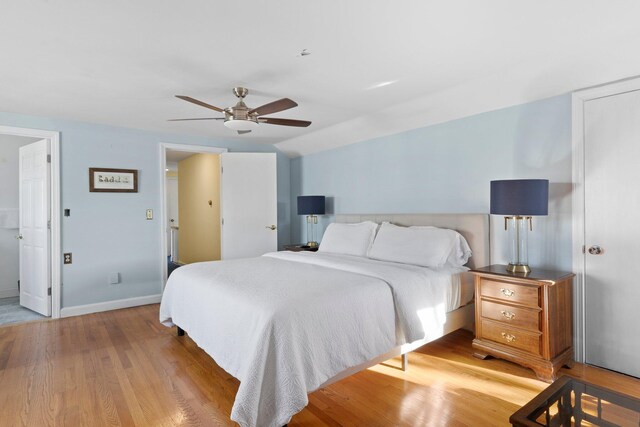 bedroom featuring light wood-type flooring, ceiling fan, and vaulted ceiling