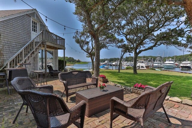 view of patio with a water view and an outdoor hangout area