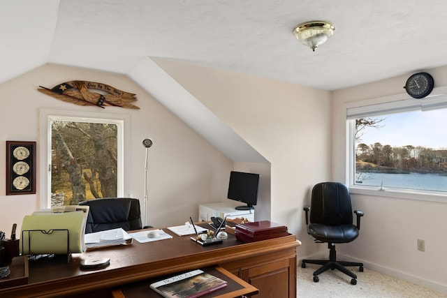 carpeted office featuring lofted ceiling