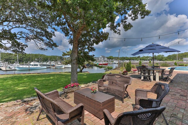 view of patio featuring a water view and outdoor lounge area