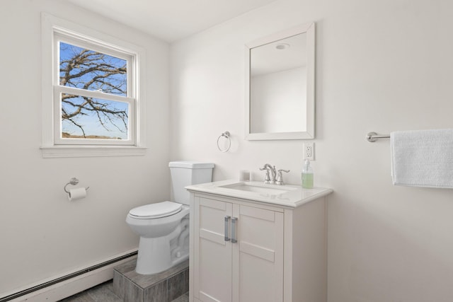 bathroom with vanity, toilet, and a baseboard radiator