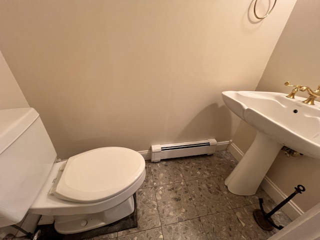 bathroom featuring toilet and a baseboard heating unit