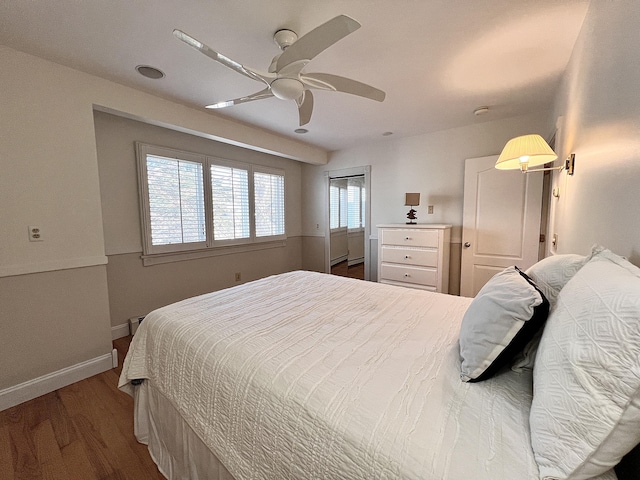 bedroom with ceiling fan and wood-type flooring