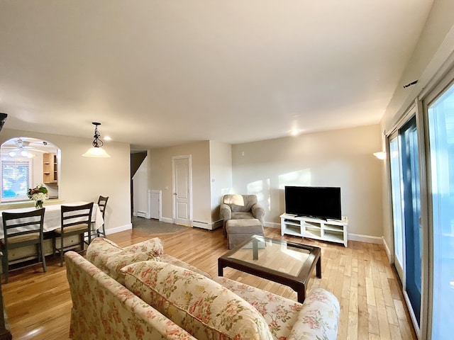 living room with ceiling fan and light hardwood / wood-style flooring