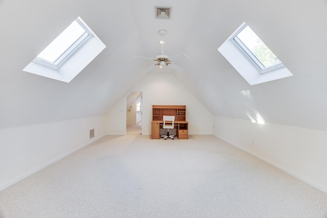 bonus room with lofted ceiling with skylight, carpet floors, and visible vents