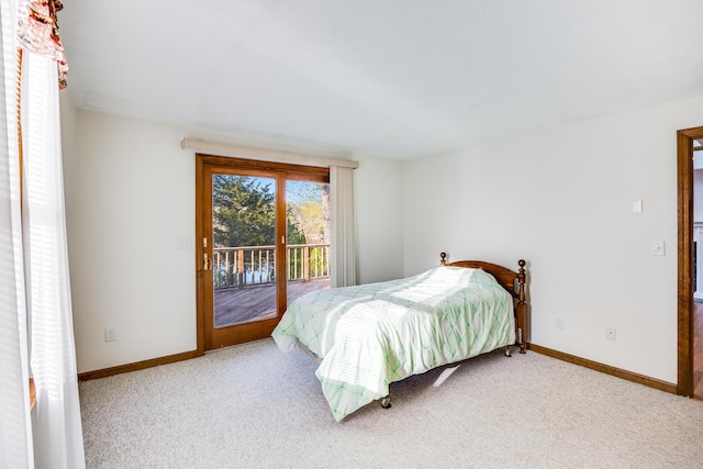 bedroom with carpet floors, access to outside, and baseboards