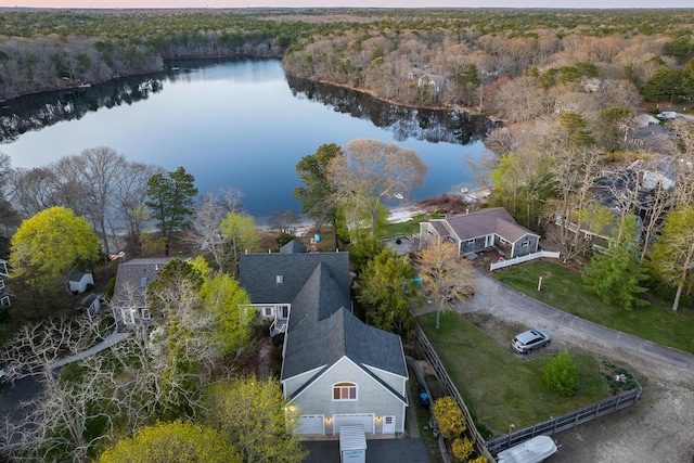 birds eye view of property featuring a water view and a view of trees