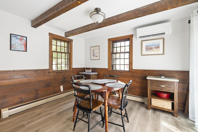 10 Devonshire Ln, South Dennis, MA 02660 - dining room featuring a wall mounted air conditioner, a baseboard radiator, wainscoting, wood walls, and light wood-style floors