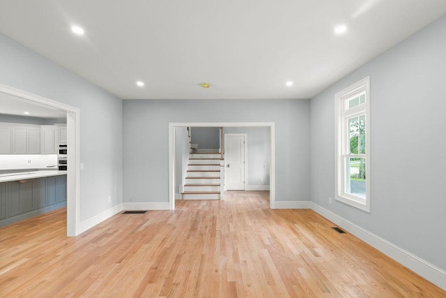 unfurnished living room featuring light wood-type flooring