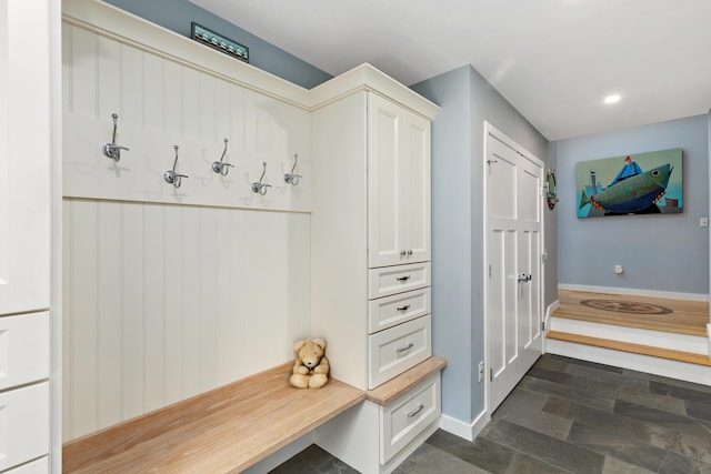 mudroom featuring dark wood-style floors and baseboards