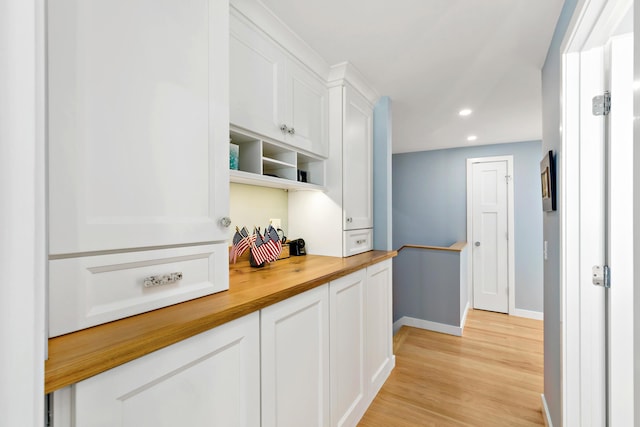 kitchen featuring open shelves, recessed lighting, light wood-style floors, white cabinetry, and butcher block countertops