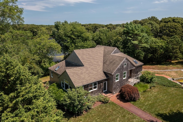 drone / aerial view with a wooded view