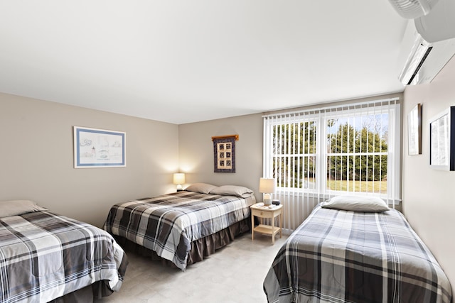 bedroom featuring a wall mounted air conditioner and light floors