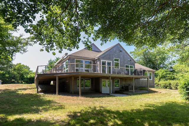 rear view of property with a yard, central AC, and a wooden deck