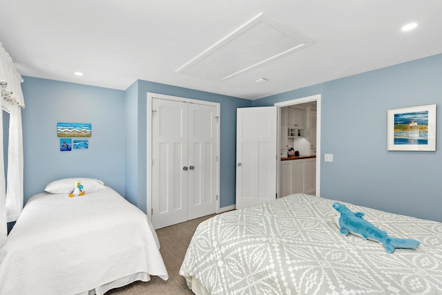 bedroom with recessed lighting, a closet, and carpet flooring