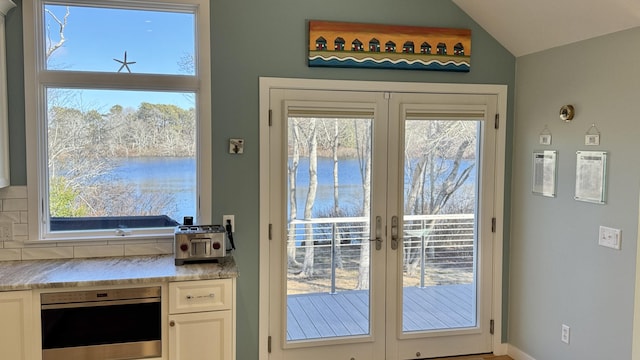 doorway to outside with french doors and vaulted ceiling