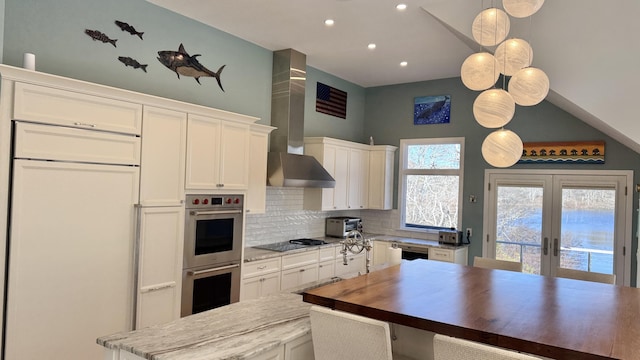 kitchen featuring black appliances, french doors, white cabinets, and decorative backsplash