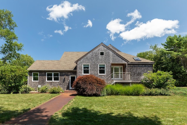 shingle-style home with a front lawn and roof with shingles