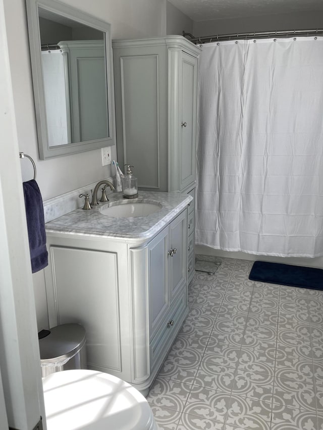 bathroom featuring tile patterned floors, a shower with curtain, and vanity