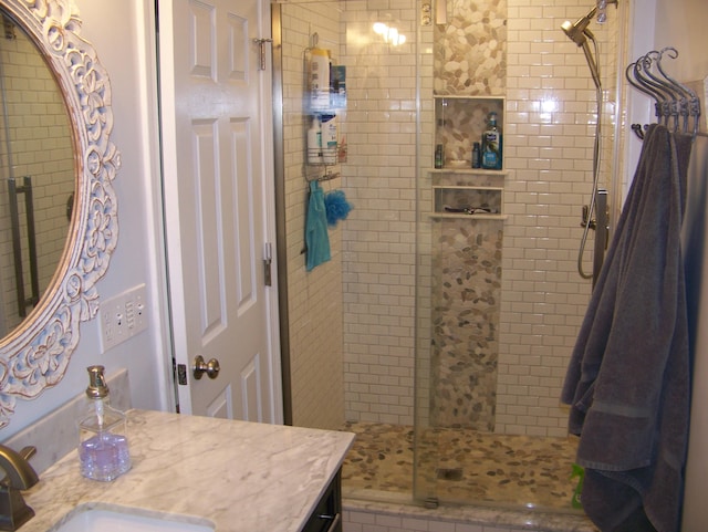 full bathroom featuring a shower stall and vanity