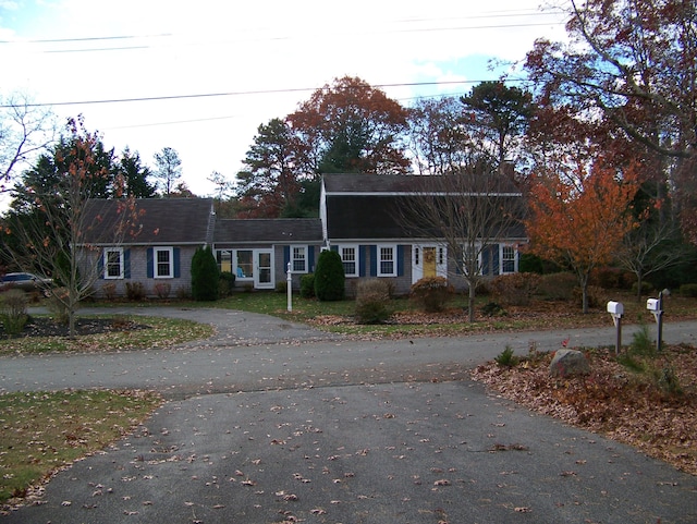 dutch colonial featuring aphalt driveway