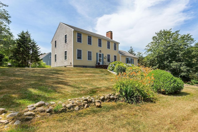 10 Briarfield Rd, South Dennis, MA 02660 - back of property featuring a chimney and a lawn