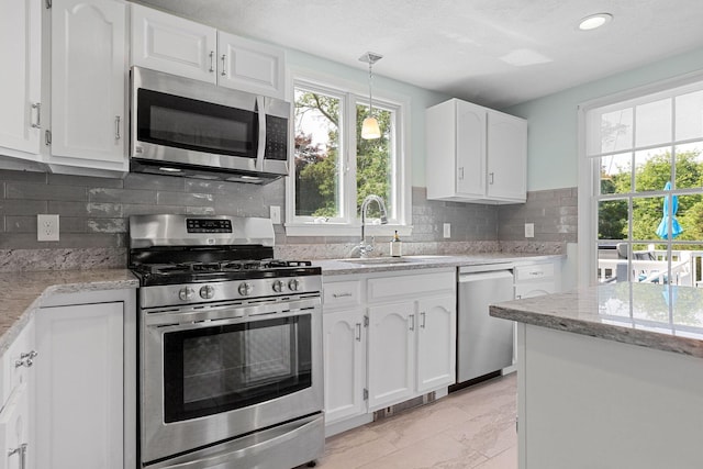 10 Briarfield Rd, South Dennis, MA 02660 - kitchen featuring stainless steel appliances, light marble finish flooring, white cabinets, tasteful backsplash, and recessed lighting