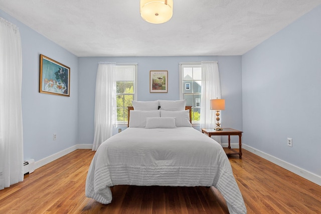 10 Briarfield Rd, South Dennis, MA 02660 - bedroom with a baseboard radiator and light wood-type flooring